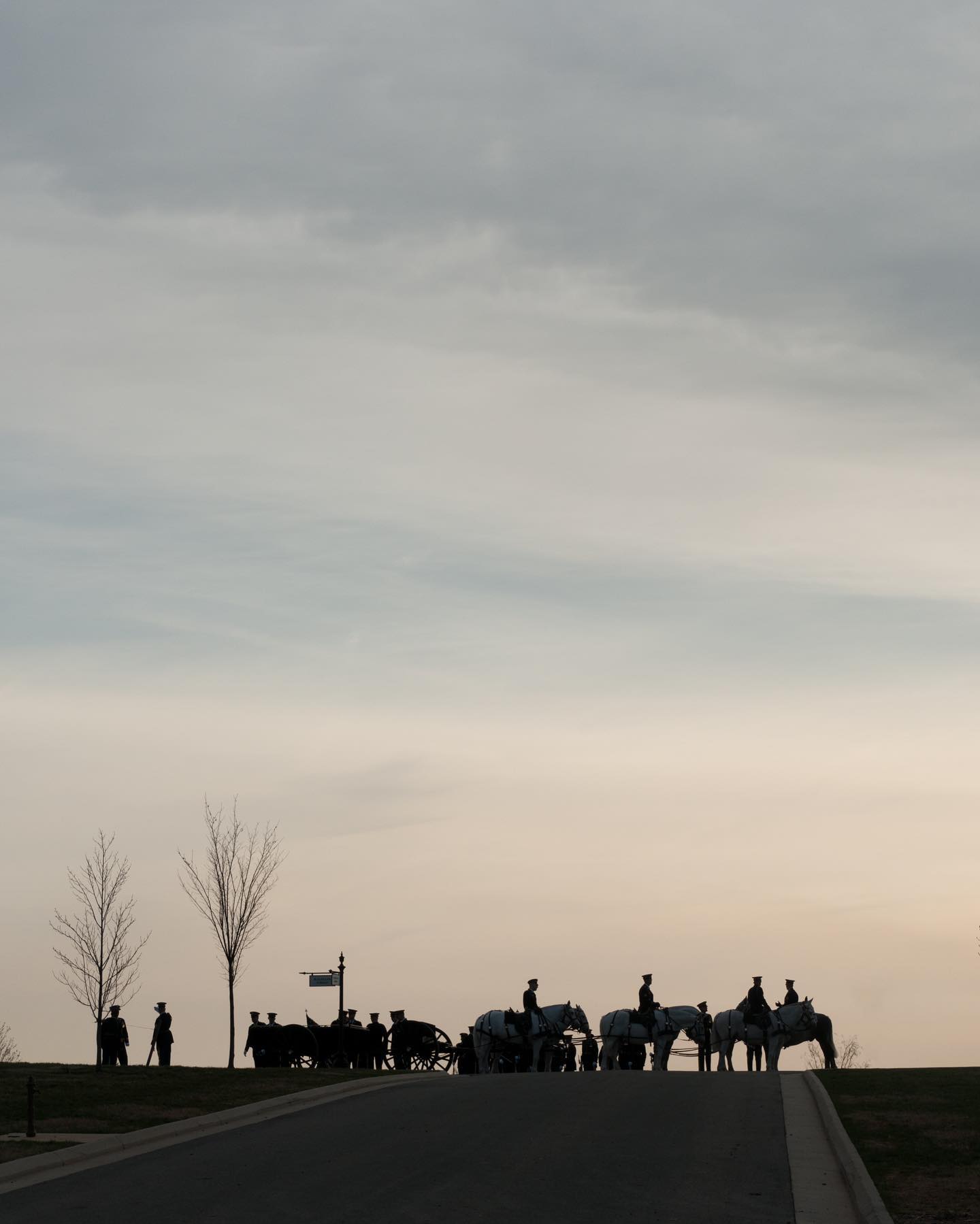 Soldiers from the 3d U.S. Infantry Regiment (The Old Guard) Caisson Platoon conducted modified military funeral honors with funeral escort for a decorated Veteran earlier this month in section 57 of Arlington National Cemetery, Arlington, Virginia.

In this photo, they lay in wait at McClellan Circle as the last rays creep across Arlington National Cemetery.