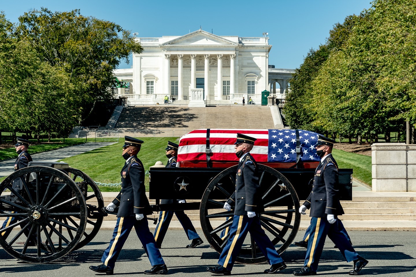 A full honors funeral service passes in front of the Tomb of the Unknown Soldier at Arlington National Cemetery on its way to a gravesite.

In March 1926, soldiers from nearby Fort Myer were first assigned to guard the Tomb of the Unknown Soldier. The guards, present only during daylight hours, discouraged visitors from climbing or stepping on the Tomb. In 1937, the guards became a 24/7 presence, standing watch over the Unknown Soldier at all times.

The 3rd U.S. Infantry Regiment, known as “The Old Guard,” was designated as the Army’s official ceremonial unit on April 6, 1948. At that time, The Old Guard began guarding the Tomb of the Unknown Soldier. Soldiers of The Old Guard also serve as escorts to the president and conduct military ceremonies in and around Washington, D.C., including military funeral escorts at Arlington National Cemetery.

Soldiers who volunteer to become Tomb Guards must undergo a strict selection process and intensive training. Each element of the Tomb Guard’s routine has meaning. The Guard marches 21 steps down the black mat behind the Tomb, turns and faces east for 21 seconds, turns and faces north for 21 seconds, and then takes 21 steps down the mat. Next, the Guard executes a sharp "shoulder-arms" movement to place his/her weapon on the shoulder closest to the visitors, signifying that he or she stands between the Tomb and any possible threat. The number 21 symbolizes the highest symbolic military honor that can be bestowed: the 21-gun salute.